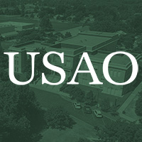 The University of Science and Art of Oklahoma name overlaid on a dark green image of a historic building