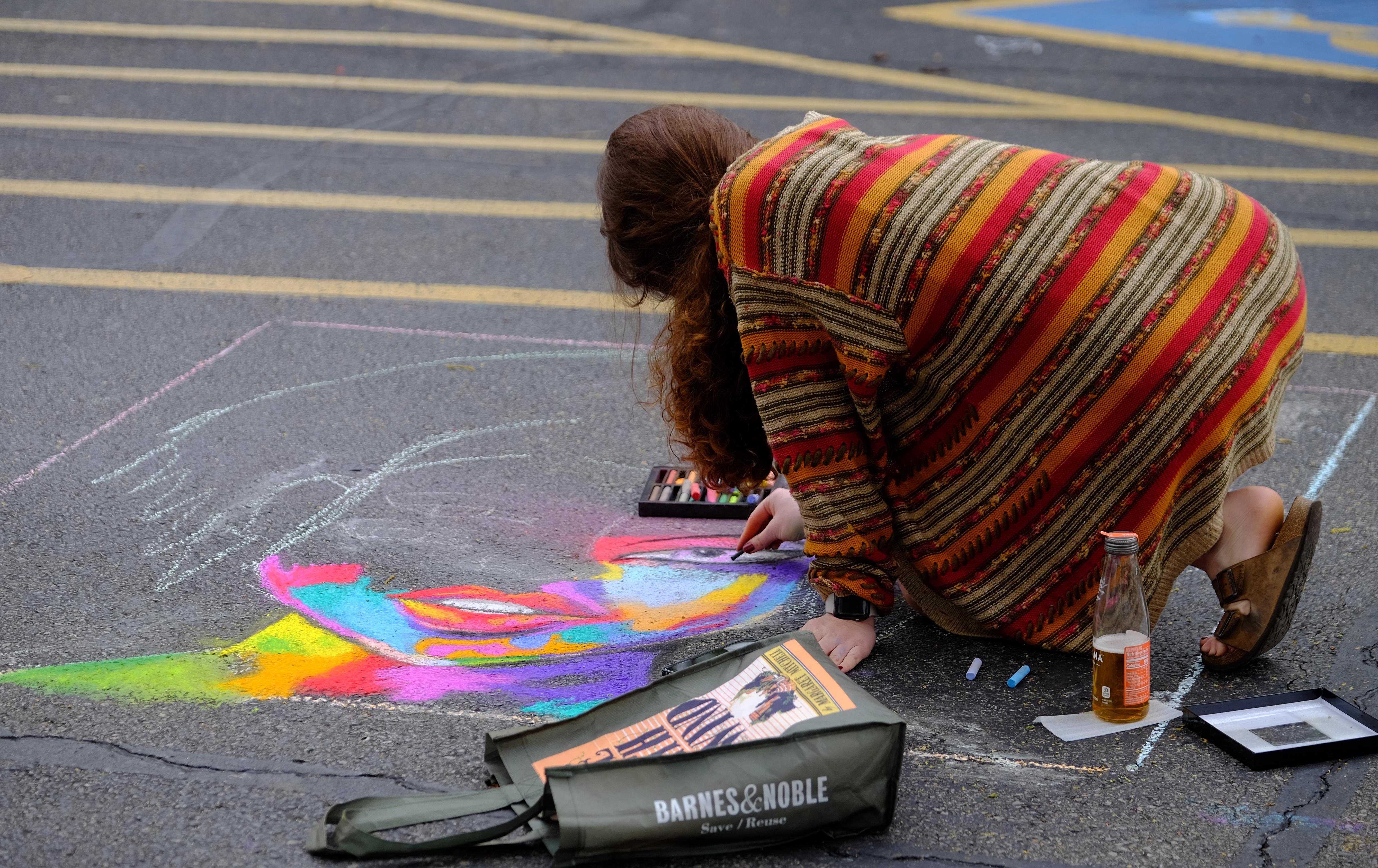 Student drawing with chalk