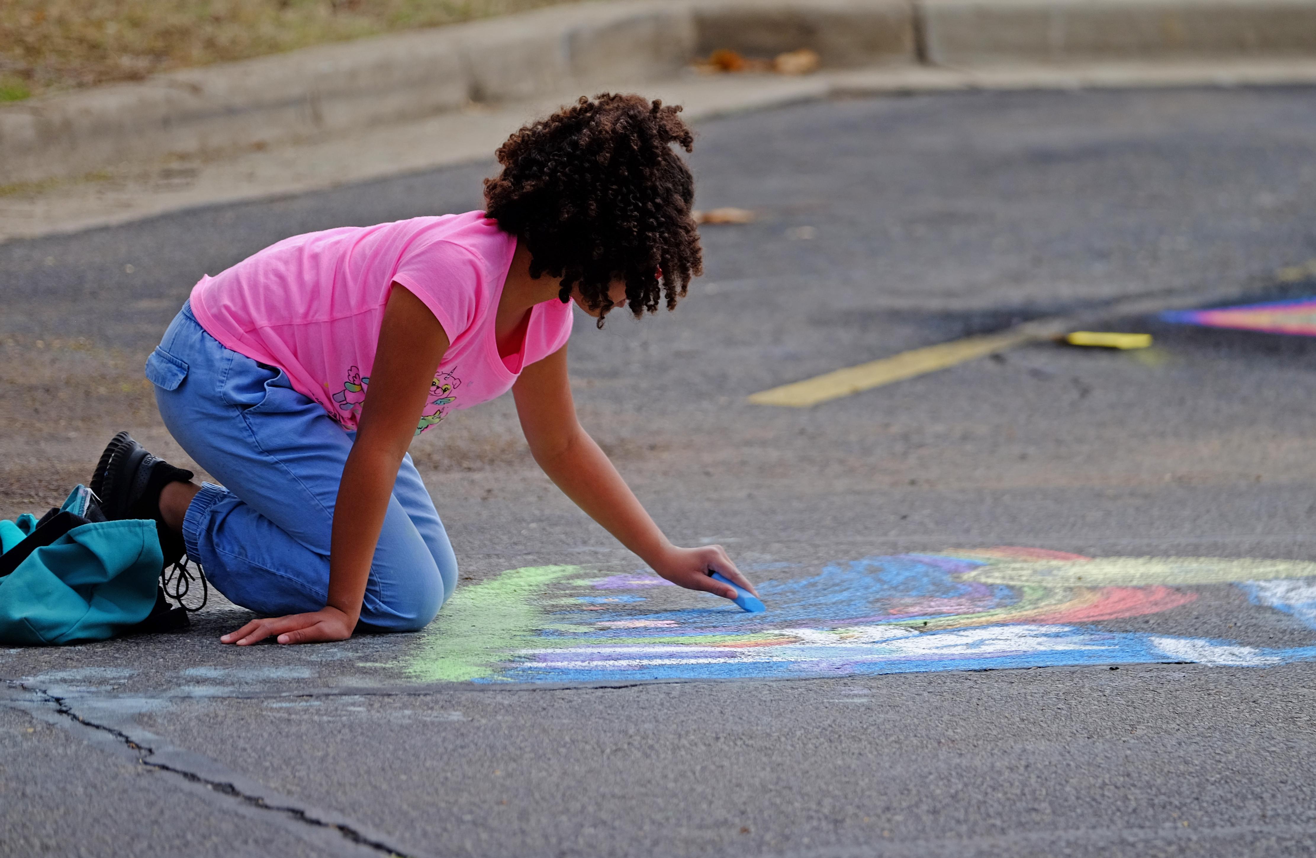 Student drawing with chalk