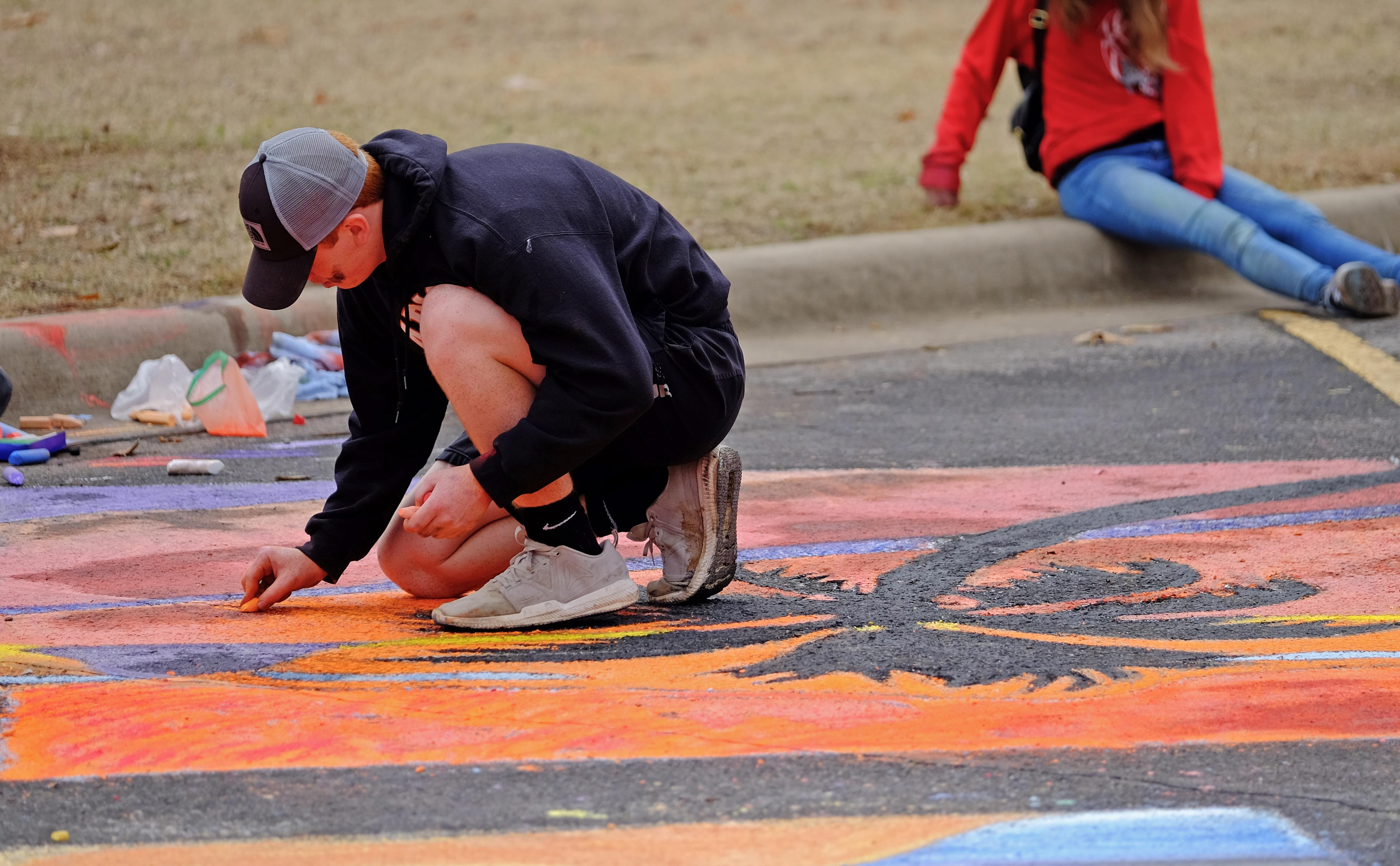 Student drawing with chalk