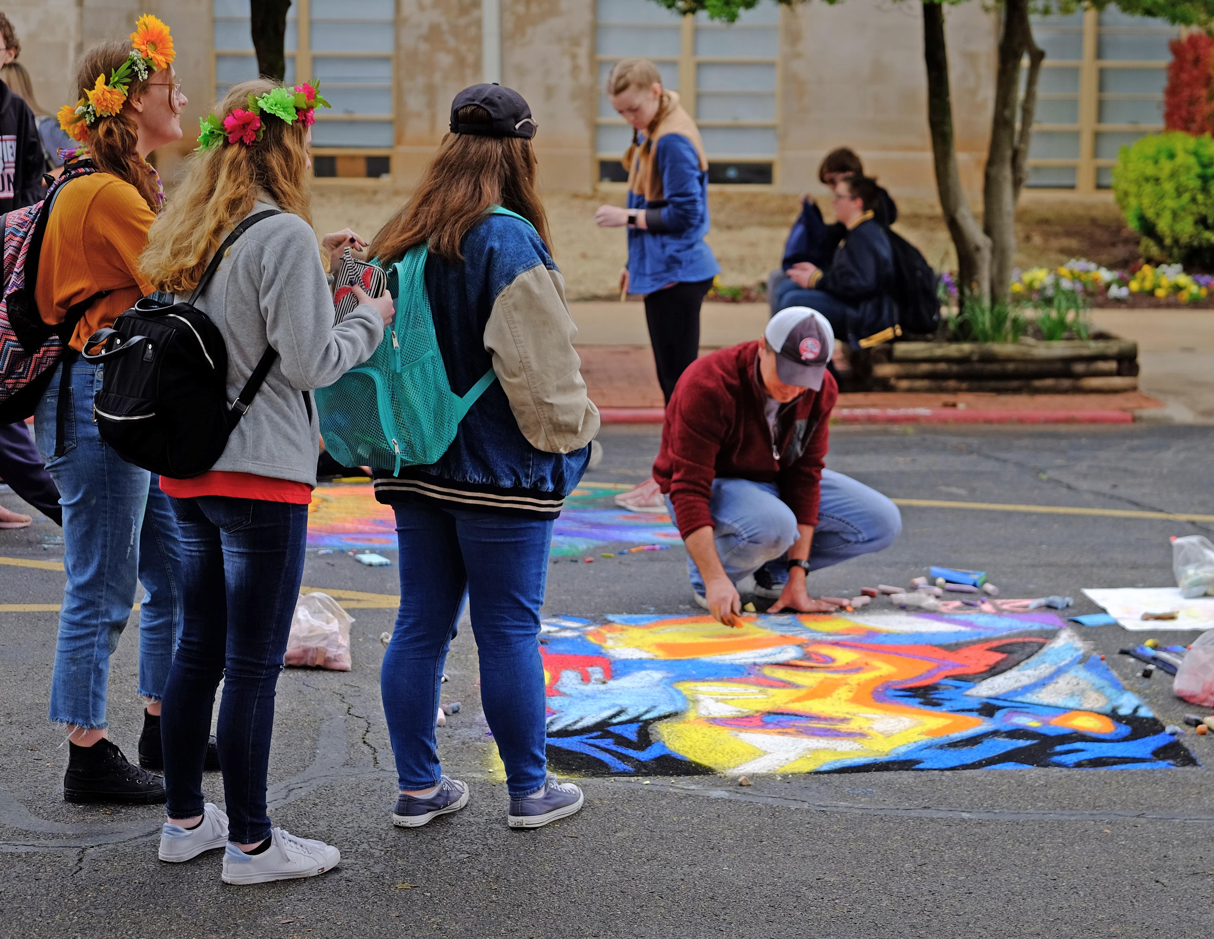 Group of students watching others draw