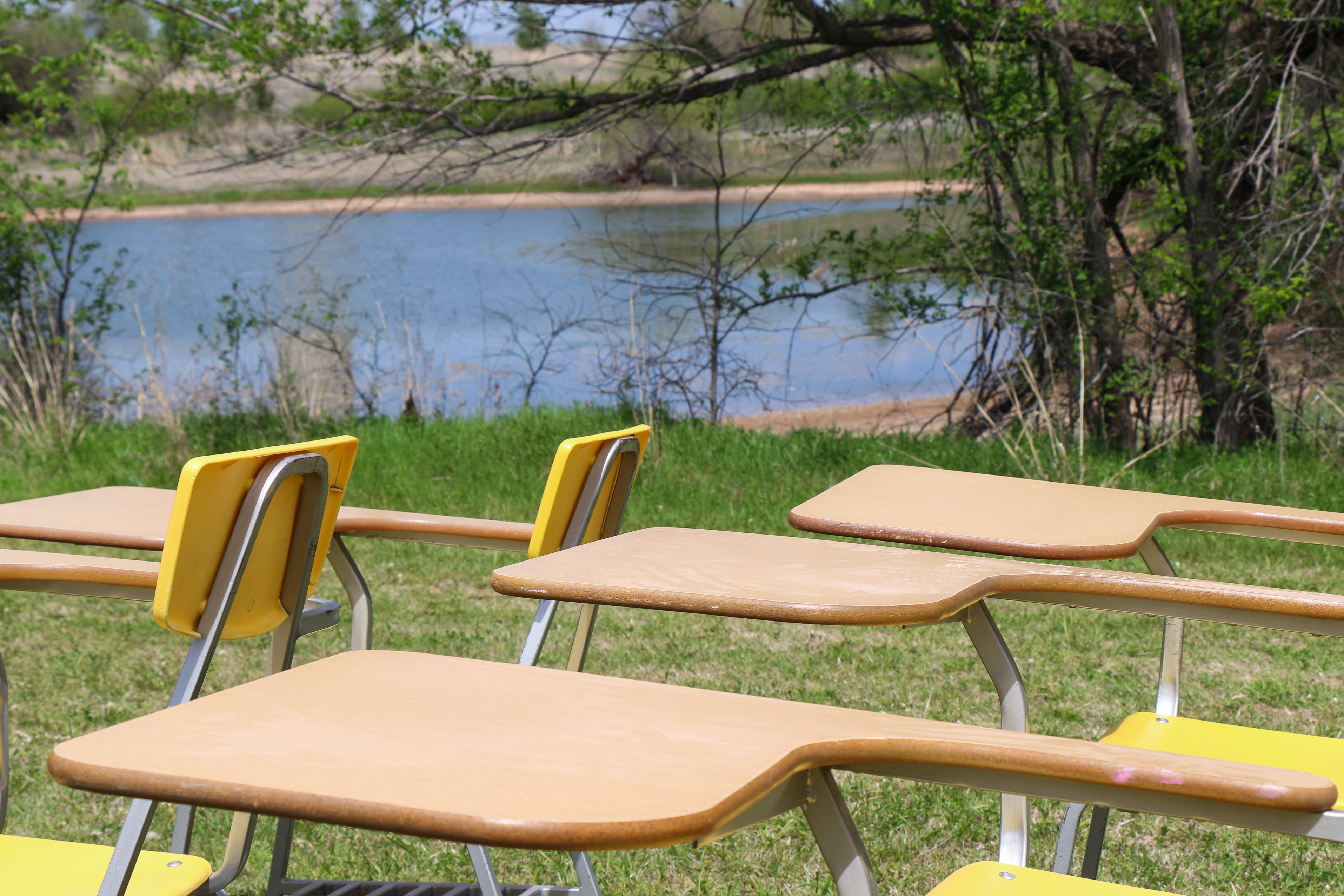 Closeup shot of desks with a pond in the background.
