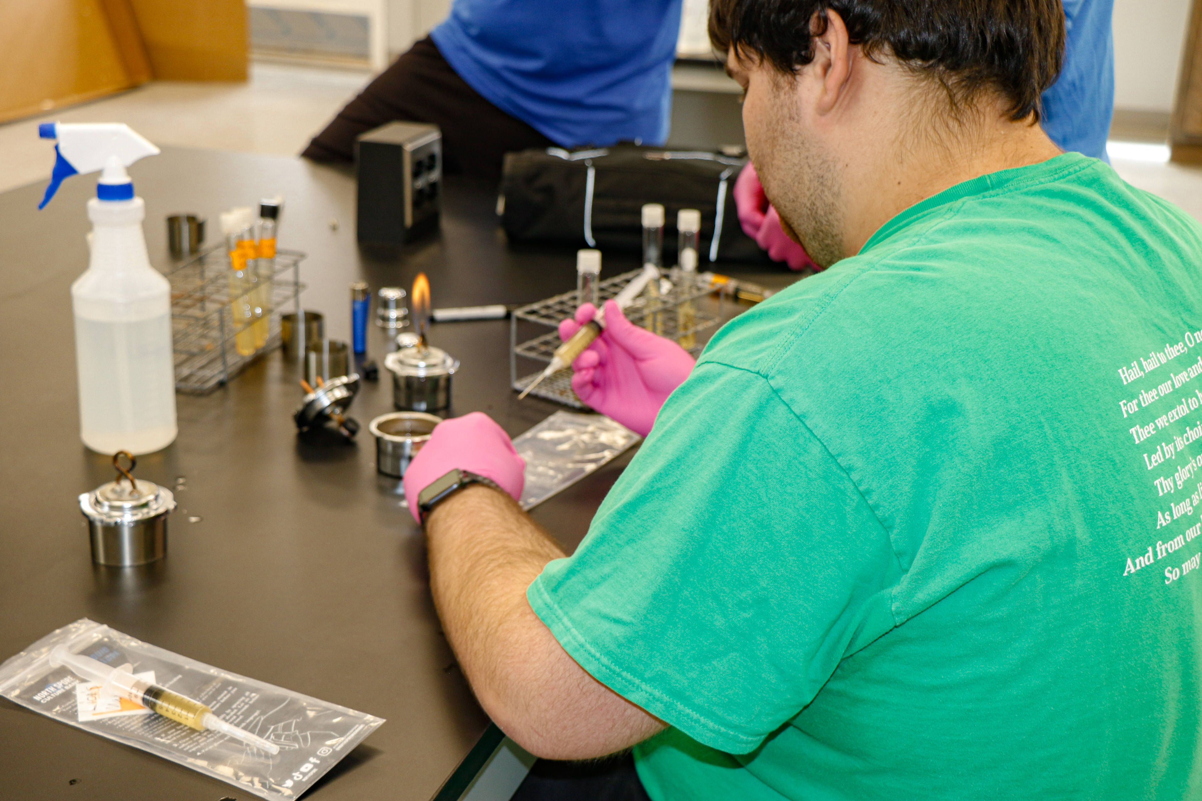 Student working with liquid culture spores.