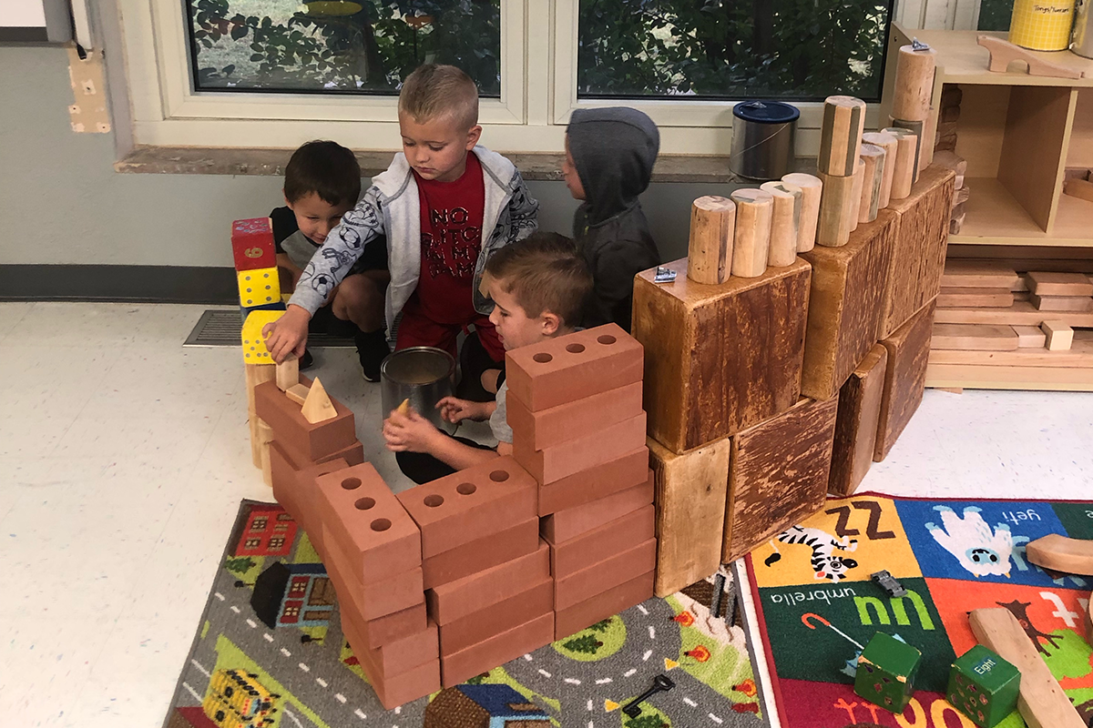 group of boys playing with building blocks