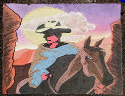 Cowboy riding a horse through a desert