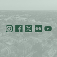 Social media icons overlaid on a light green image of campus from aerial view