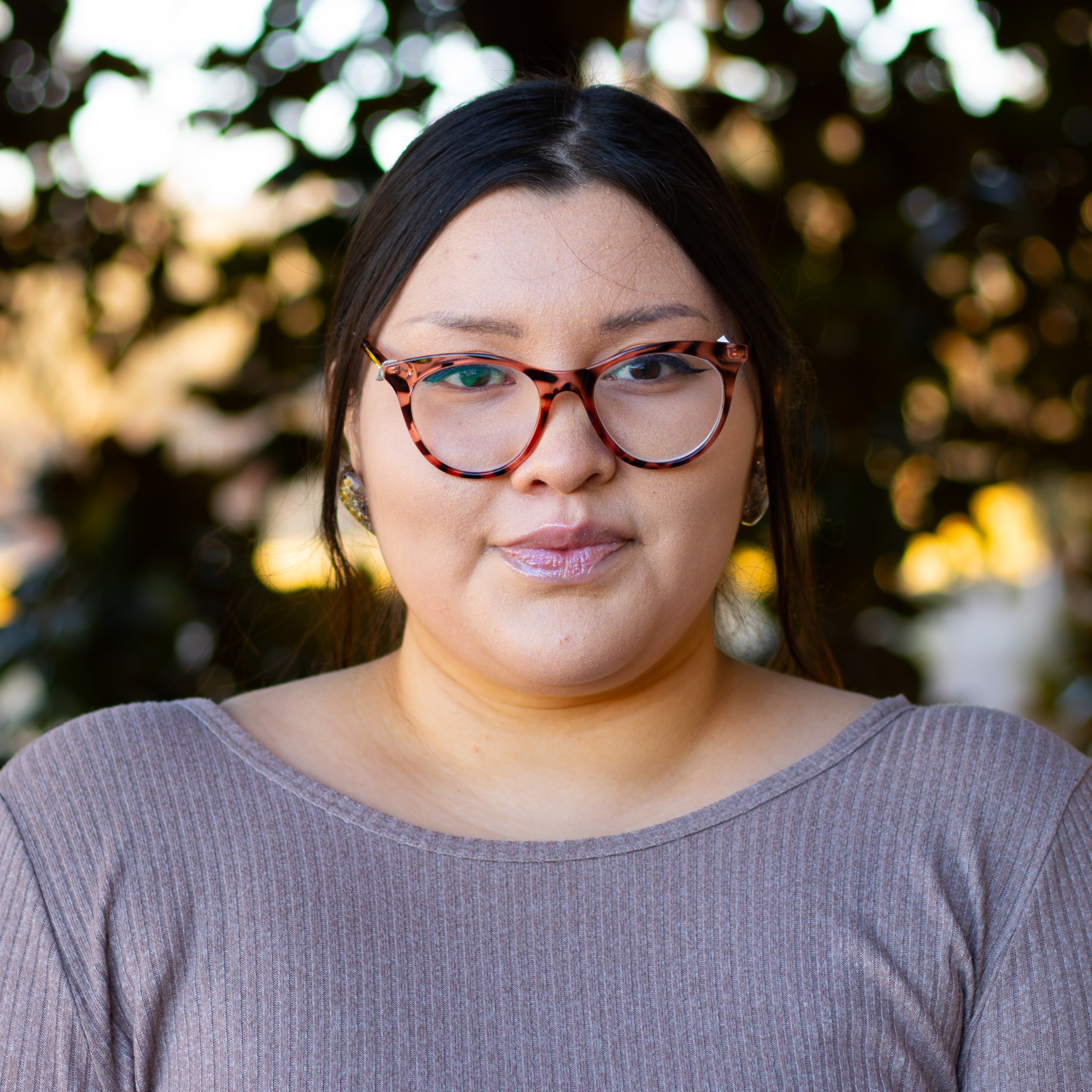 Woman in light purple sweater and glasses