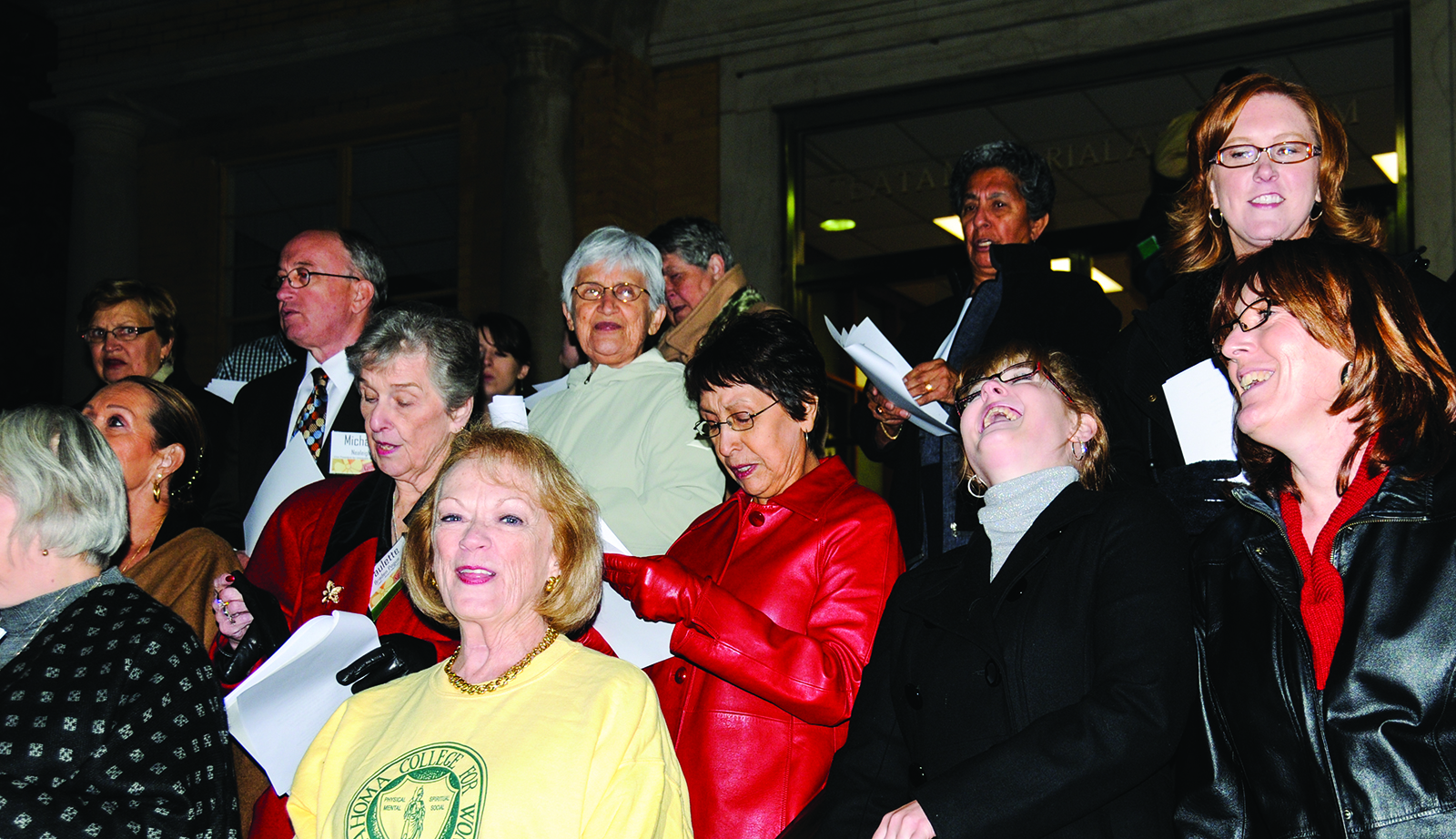 Women singing on steps of Troutt Hall