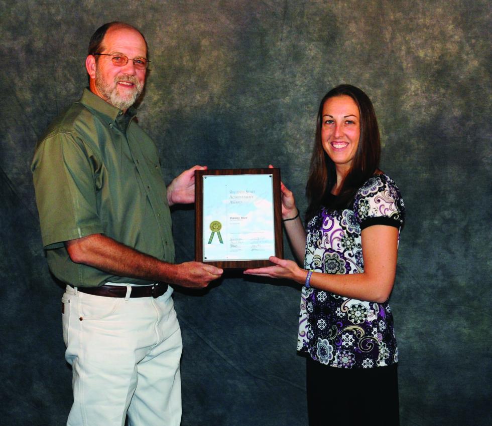 Bice receiving award with staff member 