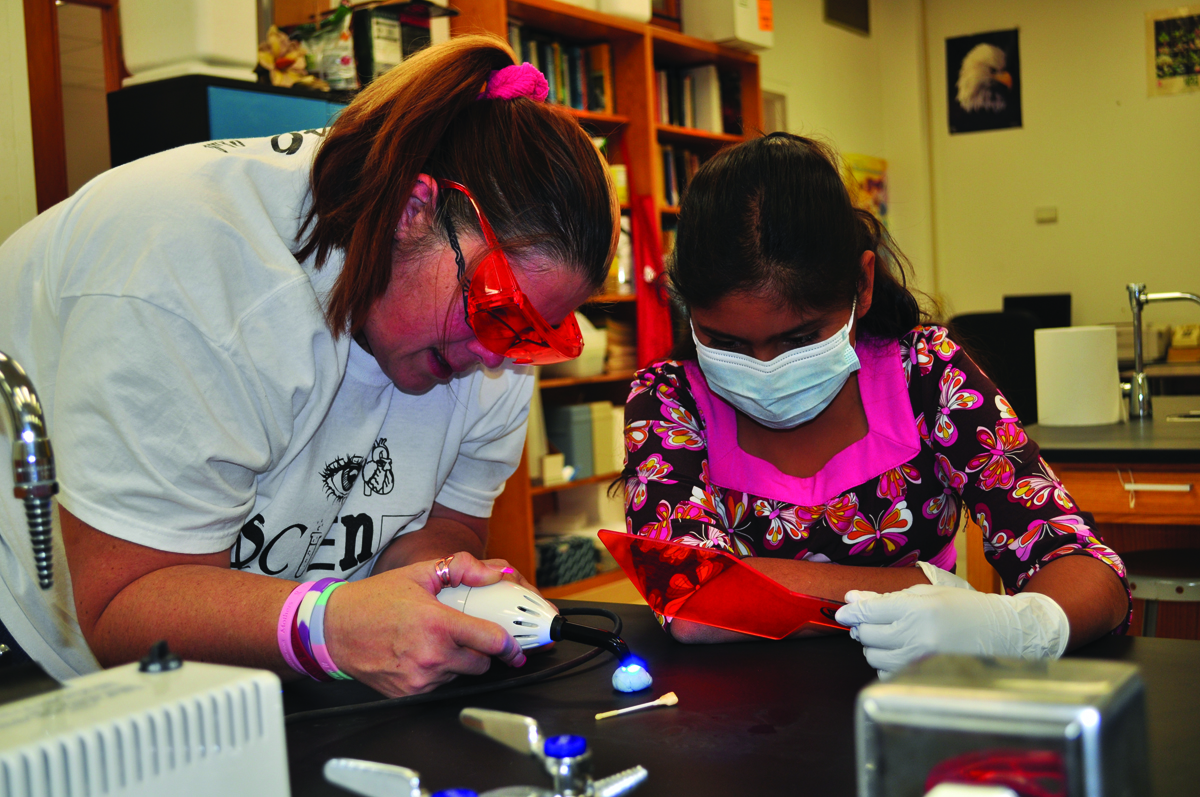 student and professor demonstrate science expirament