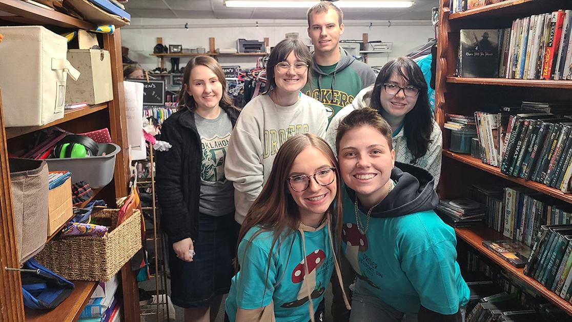 A photo of six USAO staff and students working in the thrift shop at Heidi Helping the Homeless as part of the 2023 Drover Difference Day community service event