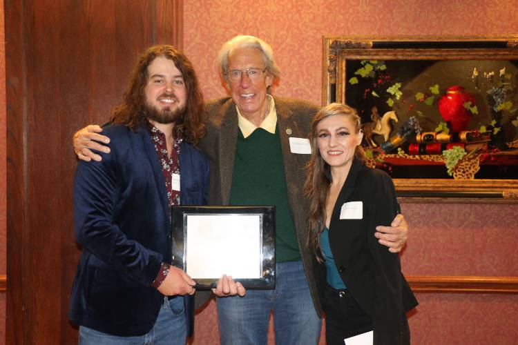 Young Alumni Award recipient Reagan Elkins stands of the far left with President John Feaver in the middle and Professor Jordan Vinyard on the far right at the 2022 Alumni Hall of Fame Brunch. 