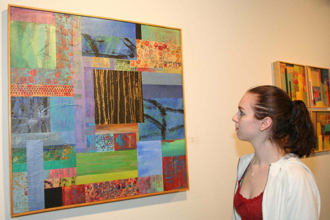 student looking at artwork