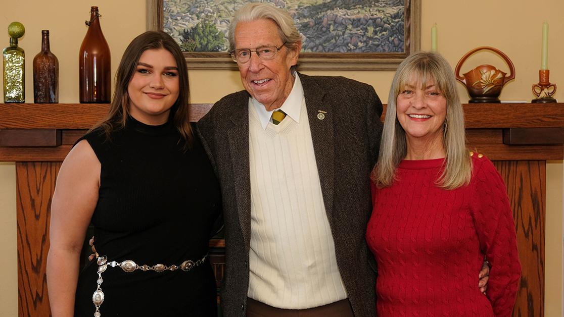 A photo of President John Feaver between granddaughter Katie Feaver to the left and wife Marilyn Feaver on the right