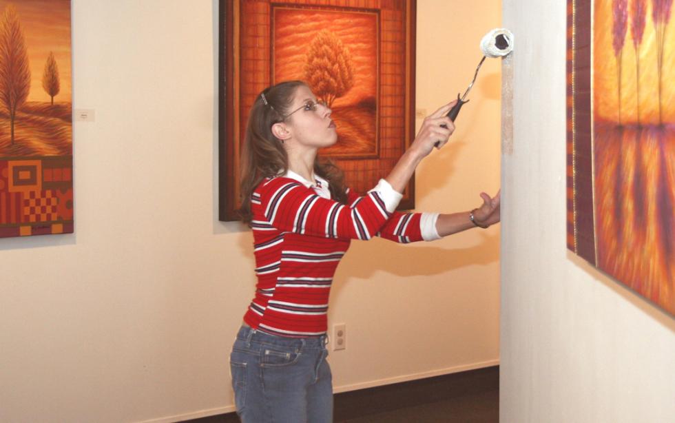 Girl painting the wall