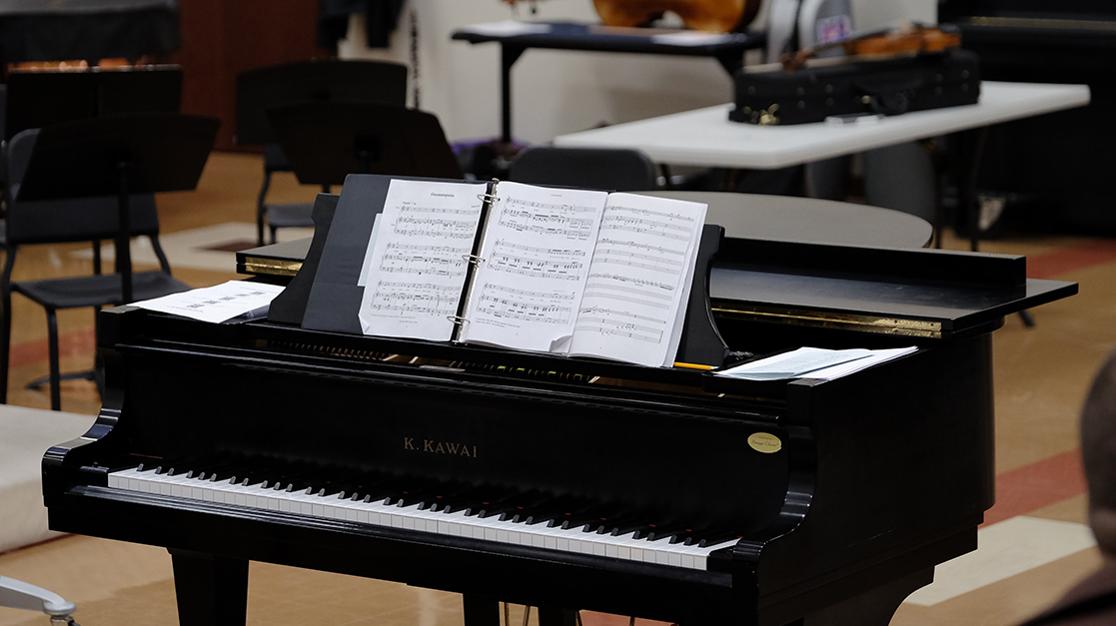 A photo of a Kawai piano with a musical score 