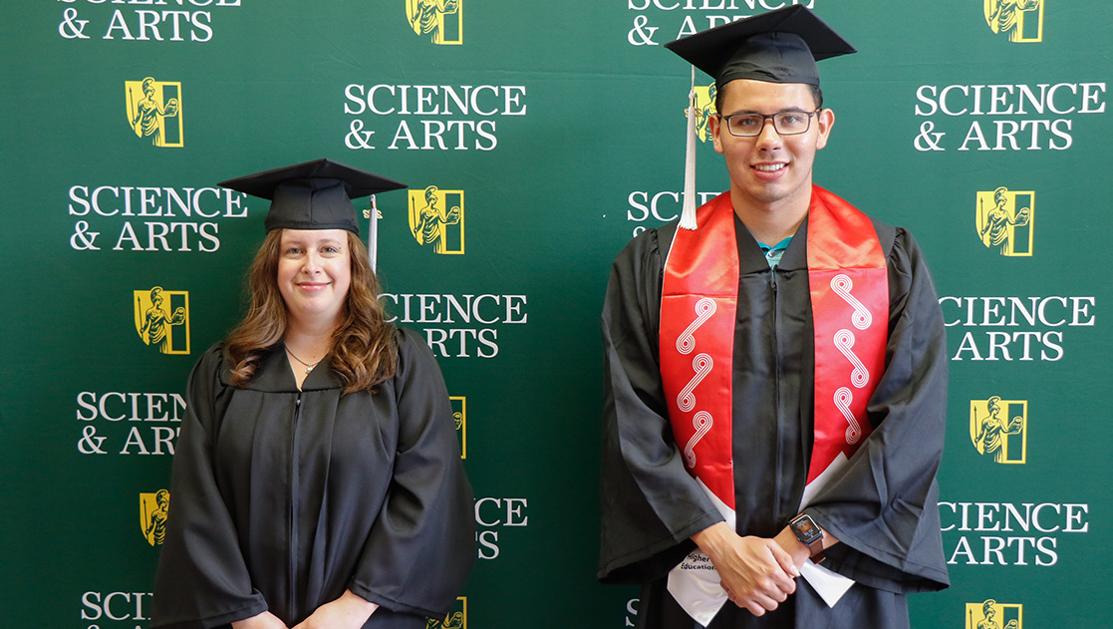 Ryleigh McDonald (left) and Alec Byrd (right) were among the first Neill-Wint Center graduates, here pictured at the Spring 2022 Commencement ceremony