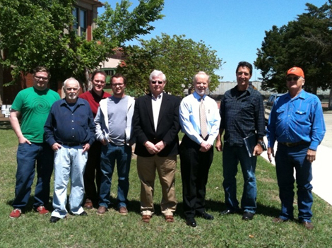 eight men posing for a picture