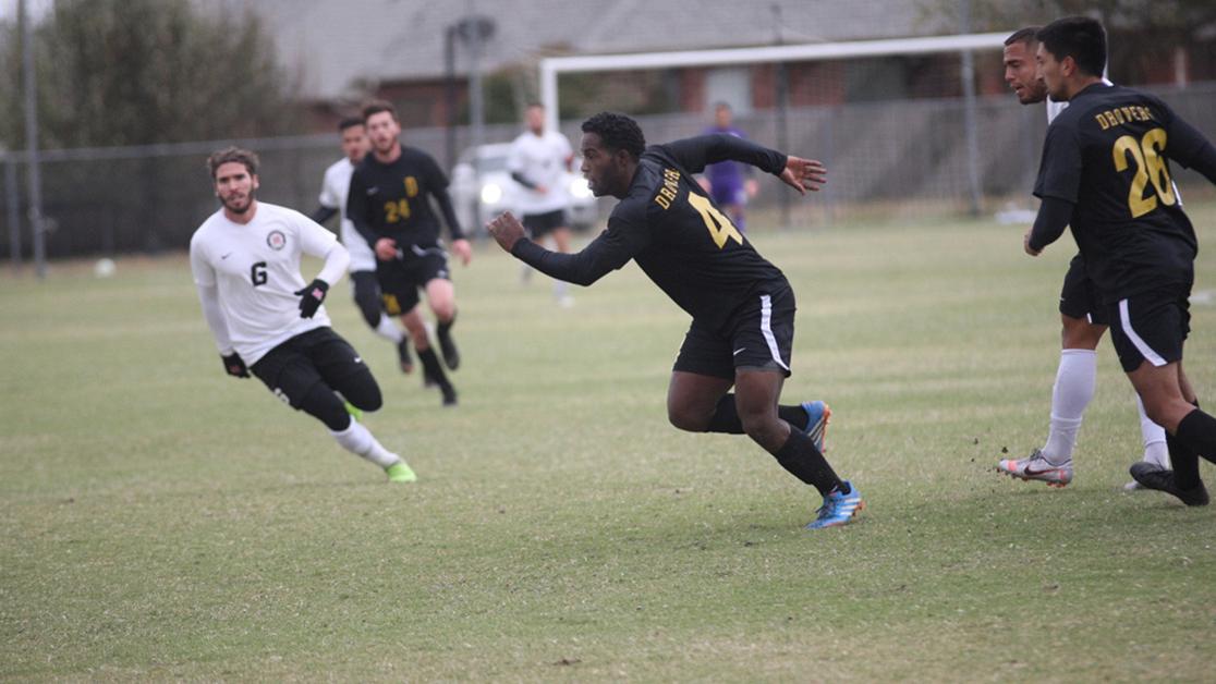 A photo of Masoma Sakwe running on the USAO soccer field with opposing players on either side. 