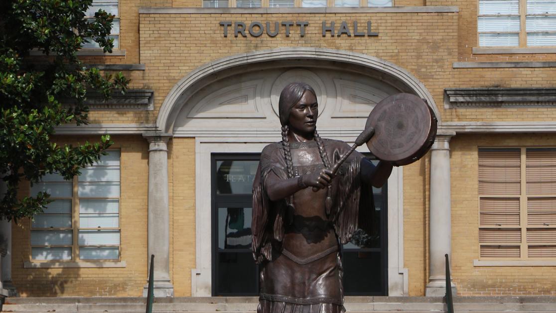 A photo of the Te Ata statue in front of Troutt Hall
