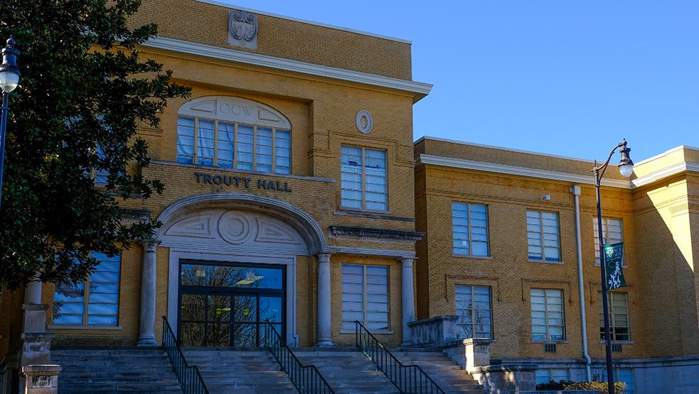 A photo of the front of Troutt Hall, showing the entry steps and sliding doors