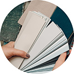 Hands holding paint swatches.